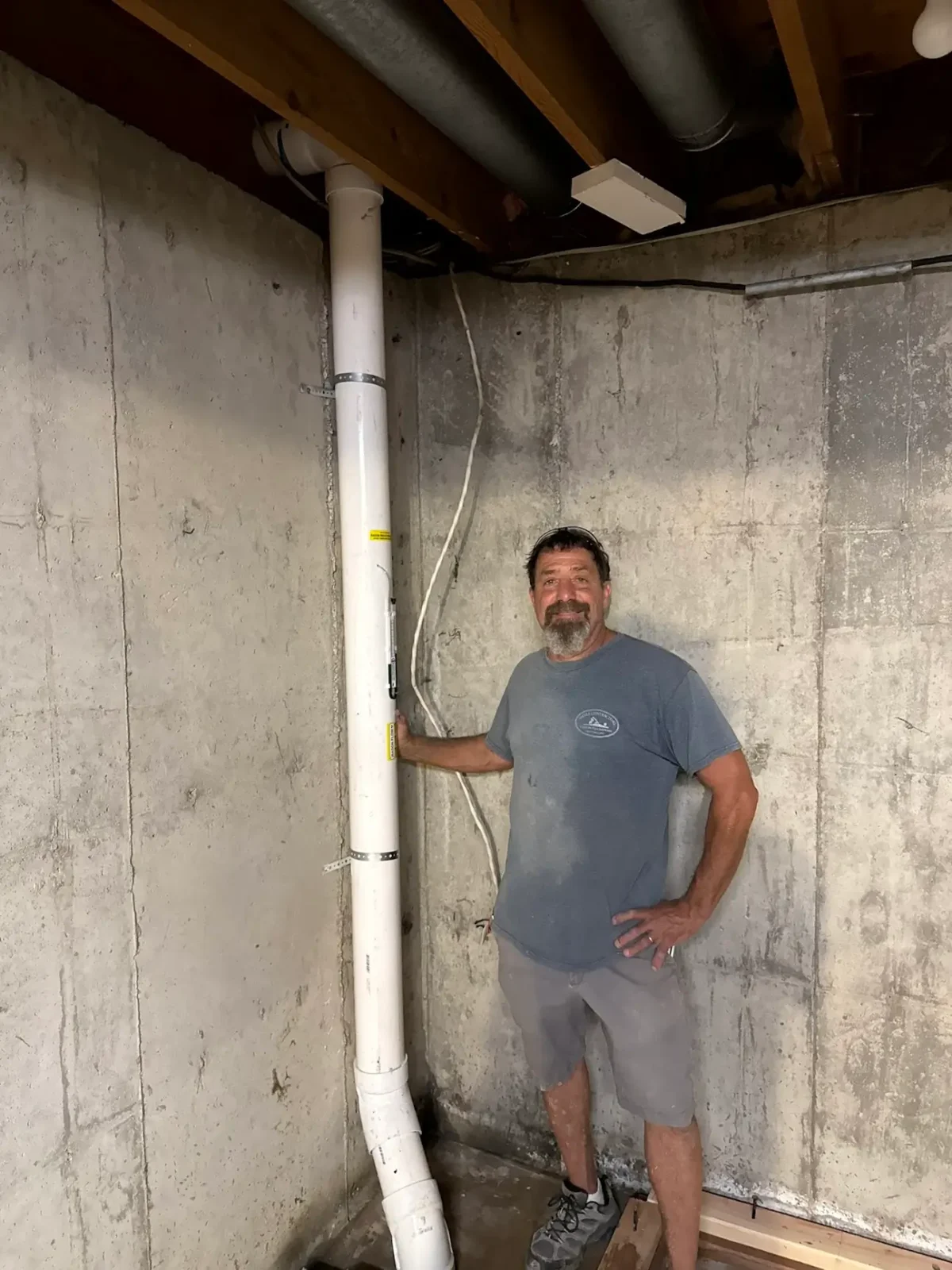 Radon mitigation pipe run in a Boulder County basement